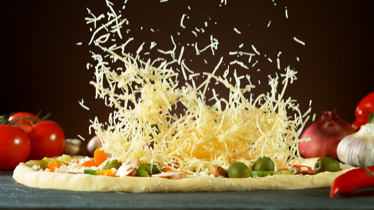 Pizza sendo preparada usando muçarela